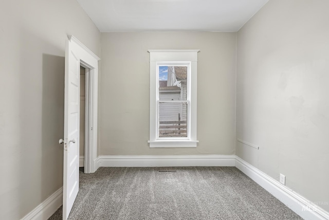 carpeted spare room with a healthy amount of sunlight