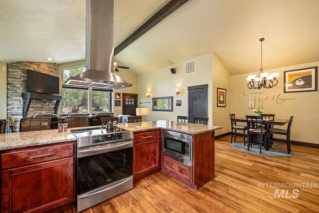 kitchen featuring island exhaust hood, light stone countertops, stainless steel appliances, a notable chandelier, and vaulted ceiling with beams