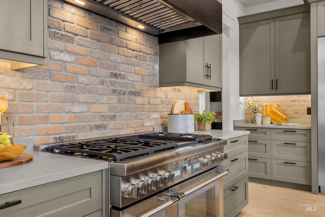 kitchen with double oven range, light countertops, and gray cabinetry