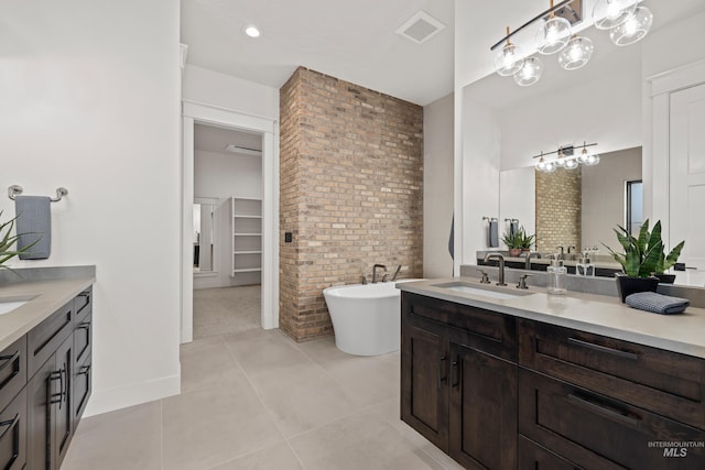 bathroom with visible vents, a notable chandelier, brick wall, and tile patterned flooring