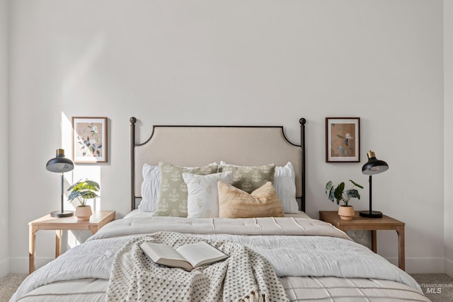 carpeted bedroom featuring baseboards