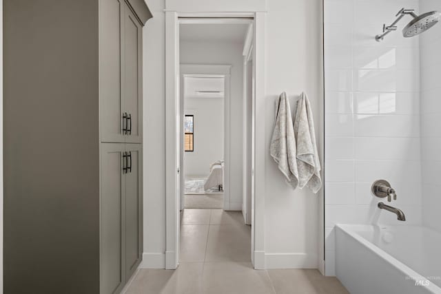 bathroom featuring tile patterned flooring,  shower combination, and baseboards