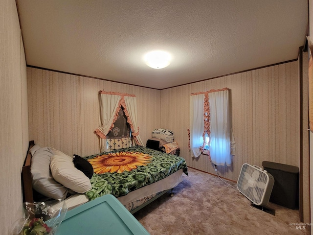 bedroom featuring a textured ceiling, carpet floors, and ornamental molding