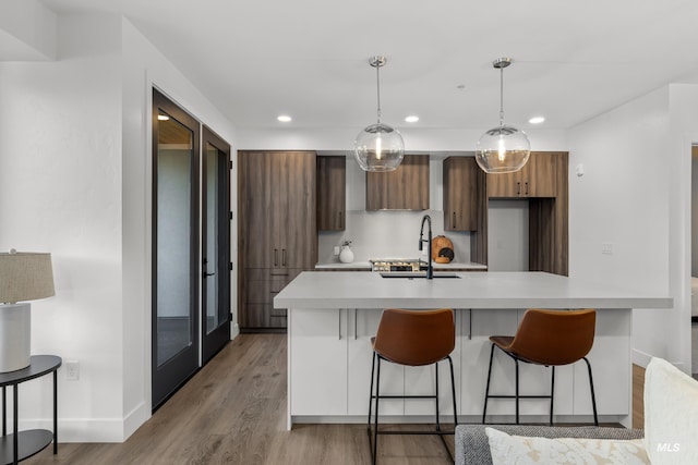 1620 W Bannock St # 303, Boise, ID 83702 - kitchen with a sink, modern cabinets, light countertops, a breakfast bar area, and recessed lighting