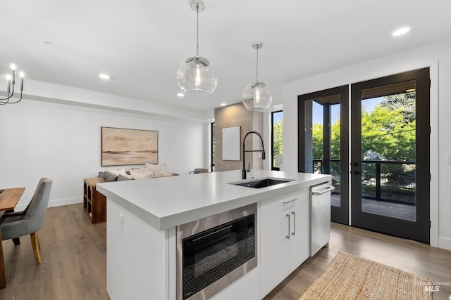 1620 W Bannock St # 303, Boise, ID 83702 - kitchen featuring built in microwave, a sink, stainless steel dishwasher, light countertops, and recessed lighting