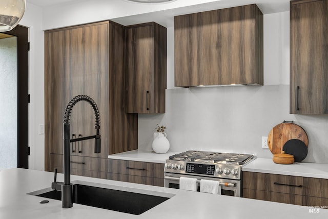 1620 W Bannock St # 303, Boise, ID 83702 - kitchen featuring stainless steel gas range oven, a sink, modern cabinets, and light countertops