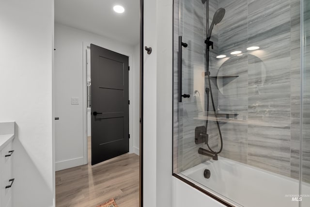 1620 W Bannock St # 303, Boise, ID 83702 - full bath with shower / bath combination with glass door, vanity, wood finished floors, baseboards, and recessed lighting