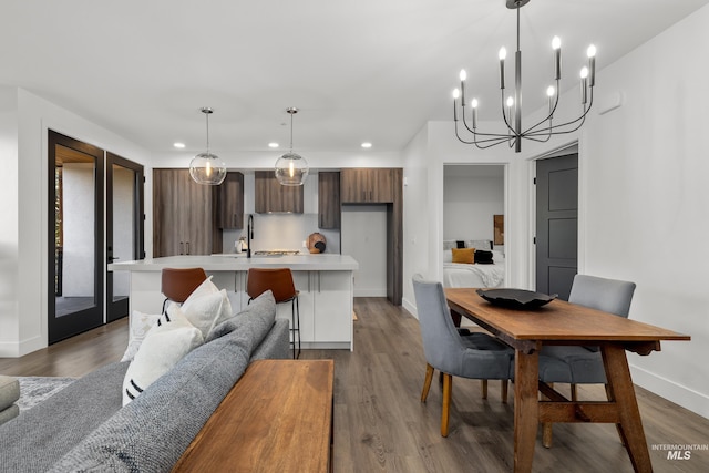 1620 W Bannock St # 303, Boise, ID 83702 - kitchen featuring light countertops, recessed lighting, modern cabinets, baseboards, and a kitchen island with sink