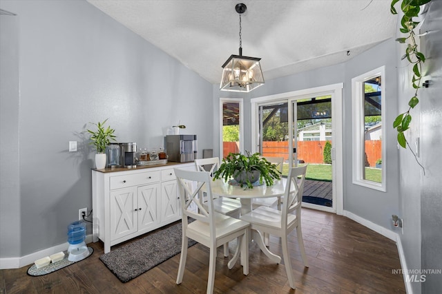 dining space with baseboards, a textured ceiling, dark wood finished floors, and a chandelier