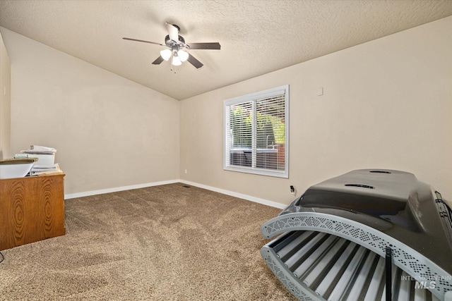 unfurnished bedroom with baseboards, a textured ceiling, a ceiling fan, carpet, and vaulted ceiling