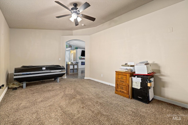 sitting room featuring baseboards, carpet flooring, and ceiling fan