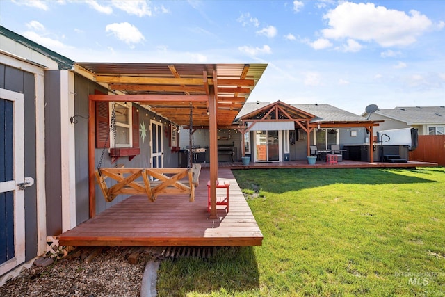 rear view of property featuring a lawn, a pergola, fence, and a wooden deck