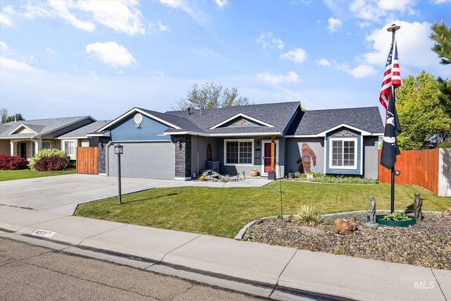 ranch-style house featuring a garage, fence, a front yard, a shingled roof, and driveway