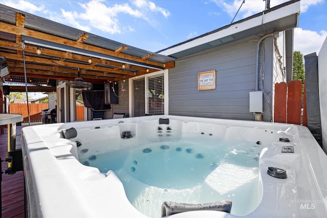 exterior space featuring a hot tub and fence
