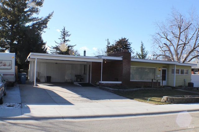 single story home featuring a carport