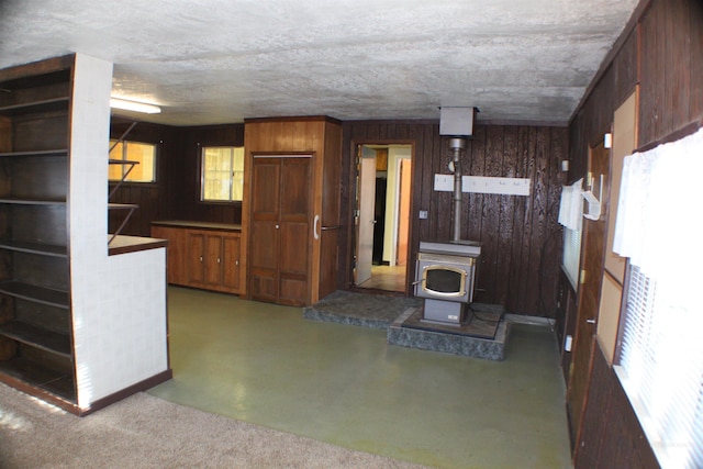 kitchen with a wood stove and wood walls