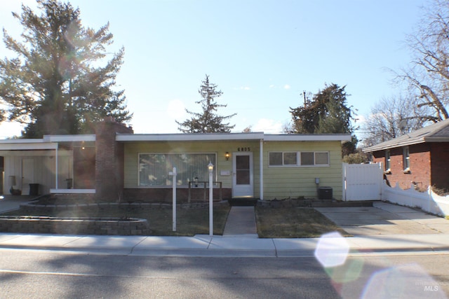 ranch-style home featuring central AC unit