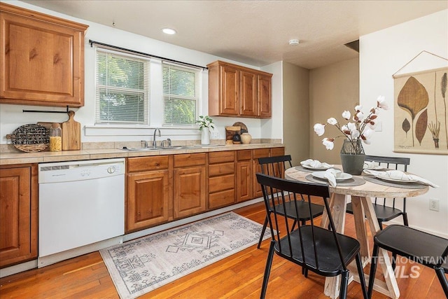 723 4th Ave N, Nampa, ID 83687 - kitchen featuring dishwasher, brown cabinetry, light countertops, light wood finished floors, and recessed lighting
