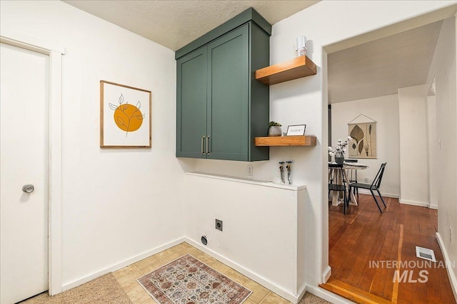 723 4th Ave N, Nampa, ID 83687 - laundry area with cabinet space, electric dryer hookup, and wood finished floors