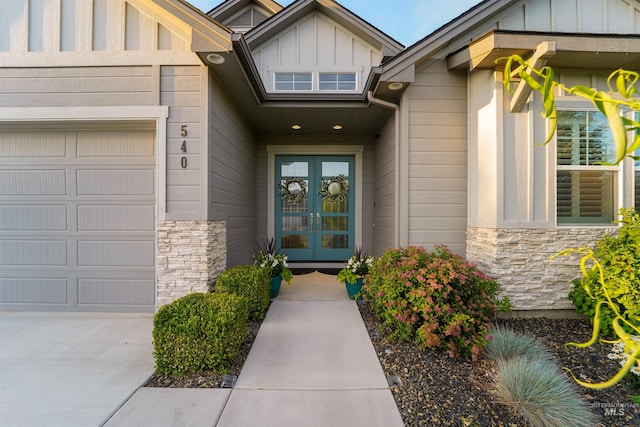 540 E Andes Dr, Kuna, ID 83634 - doorway to property with french doors, stone siding, a garage, and board and batten siding