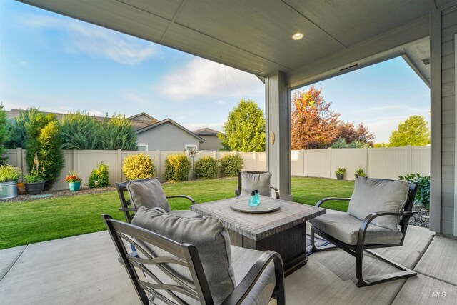 540 E Andes Dr, Kuna, ID 83634 - fenced backyard with an outdoor hangout area and a patio