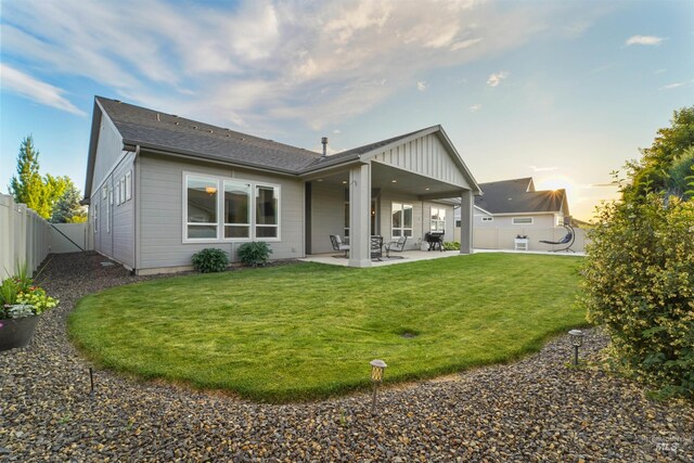 540 E Andes Dr, Kuna, ID 83634 - back of house with a fenced backyard, a patio area, and roof with shingles