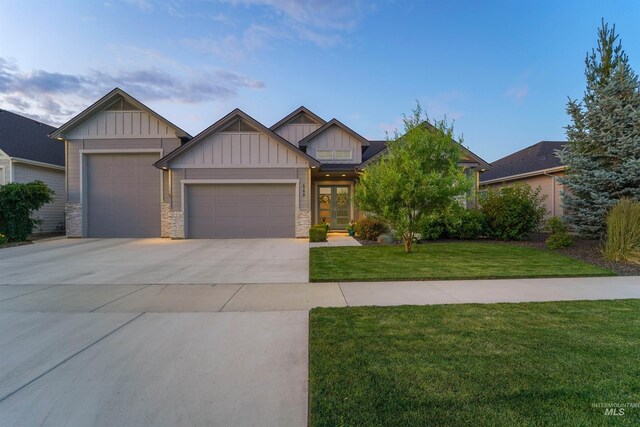 540 E Andes Dr, Kuna, ID 83634 - craftsman-style home with board and batten siding, an attached garage, a front lawn, driveway, and stone siding