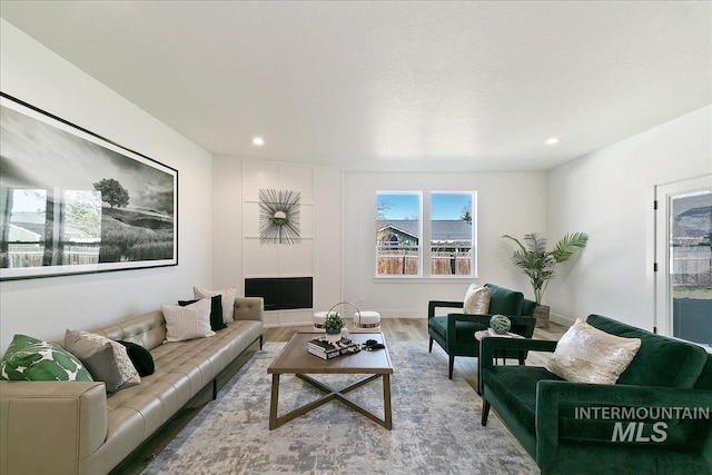 living room with hardwood / wood-style floors and a textured ceiling