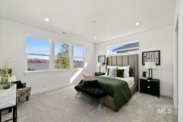 carpeted bedroom featuring multiple windows