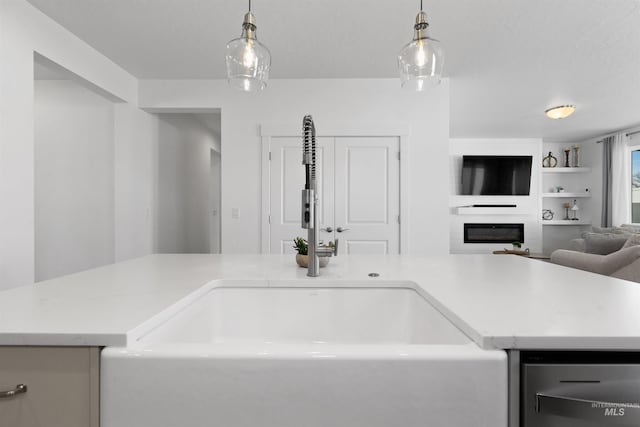 8333 S Updale Ave, Meridian, ID 83642 - kitchen featuring open floor plan, a large fireplace, a sink, and hanging light fixtures