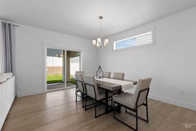 8333 S Updale Ave, Meridian, ID 83642 - dining space with light wood-style flooring, baseboards, and a notable chandelier
