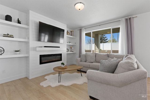 8333 S Updale Ave, Meridian, ID 83642 - living area with a fireplace, wood finished floors, baseboards, and built in shelves