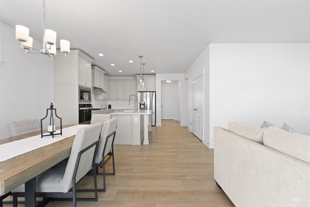8333 S Updale Ave, Meridian, ID 83642 - dining space with an inviting chandelier, light wood finished floors, and recessed lighting