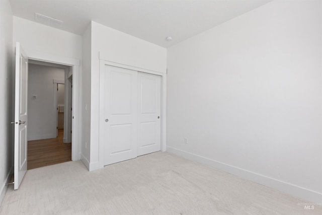 8333 S Updale Ave, Meridian, ID 83642 - unfurnished bedroom with light carpet, baseboards, visible vents, and a closet