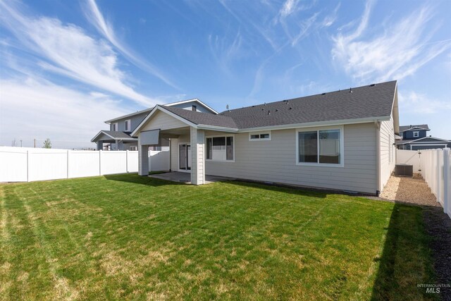 8333 S Updale Ave, Meridian, ID 83642 - rear view of house with a patio area, central air condition unit, a fenced backyard, a yard, and roof with shingles