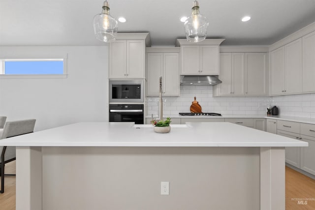 8333 S Updale Ave, Meridian, ID 83642 - kitchen featuring tasteful backsplash, built in microwave, oven, gas stovetop, and under cabinet range hood