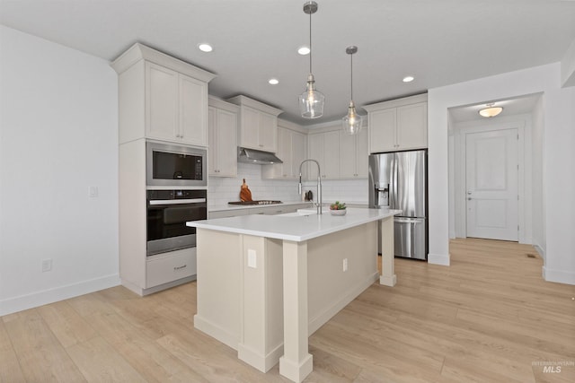 8333 S Updale Ave, Meridian, ID 83642 - kitchen with recessed lighting, under cabinet range hood, stainless steel appliances, light countertops, and decorative backsplash