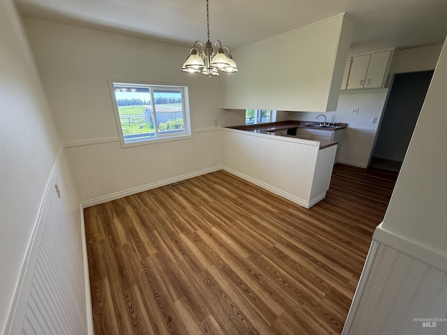 5656 Three Mile Rd, Weippe, ID 83553 - kitchen featuring wainscoting, wood finished floors, a chandelier, dark countertops, and a sink