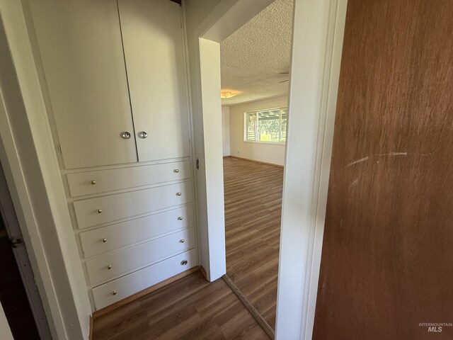 5656 Three Mile Rd, Weippe, ID 83553 - corridor featuring dark wood-style flooring and a textured ceiling