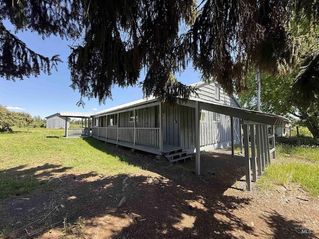 5656 Three Mile Rd, Weippe, ID 83553 - rear view of house featuring board and batten siding and a lawn