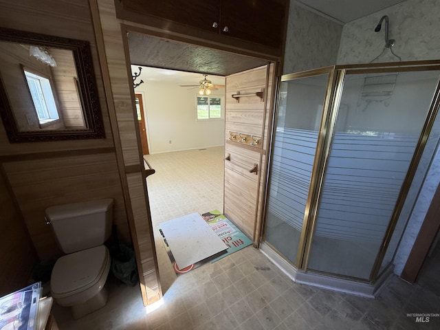 5656 Three Mile Rd, Weippe, ID 83553 - bathroom featuring toilet, a shower stall, a ceiling fan, and baseboards