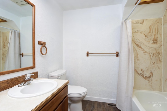 full bathroom featuring visible vents, baseboards, toilet, wood finished floors, and vanity