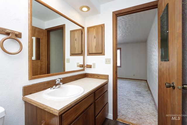 bathroom featuring baseboards and vanity