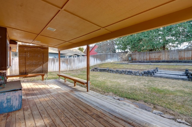 wooden terrace with visible vents, a lawn, and a fenced backyard