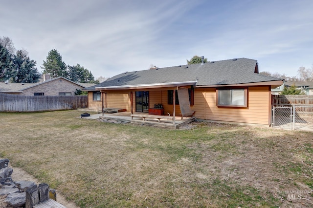 back of house with a gate, a yard, a patio area, and a fenced backyard