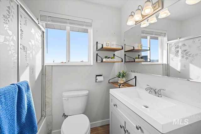 full bathroom featuring bath / shower combo with glass door, vanity, toilet, and wood-type flooring