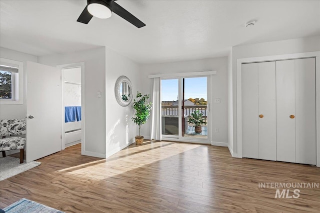 foyer with ceiling fan and light hardwood / wood-style flooring