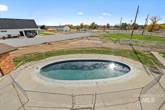 view of swimming pool with a hot tub