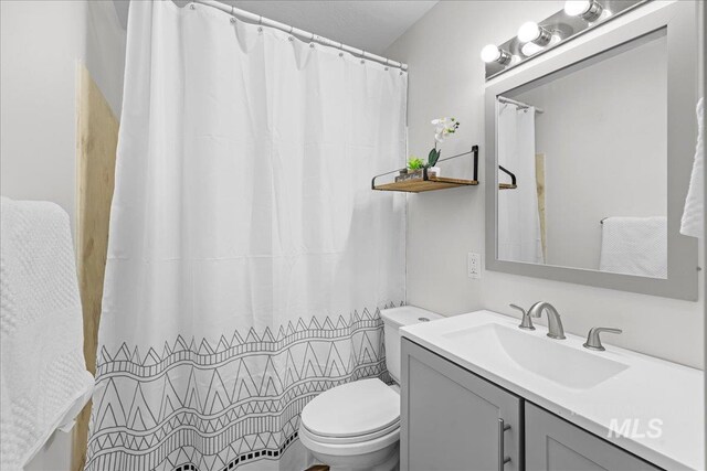 bathroom with vanity, toilet, and a shower with curtain