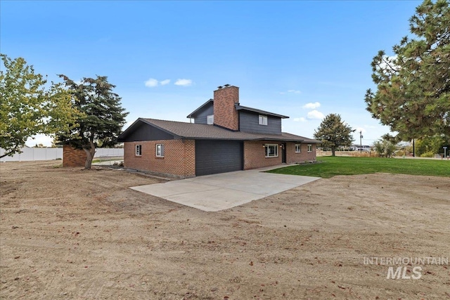 view of side of property with a lawn and a garage